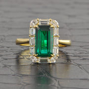 Elongated Emerald and Diamond Halo Ring in Yellow Gold