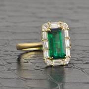 Elongated Emerald and Diamond Halo Ring in Yellow Gold