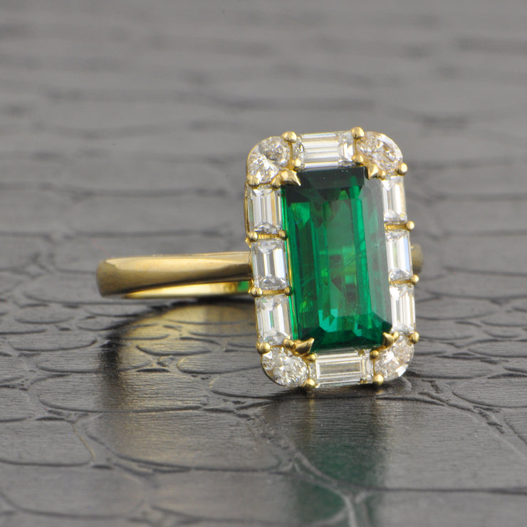 Elongated Emerald and Diamond Halo Ring in Yellow Gold